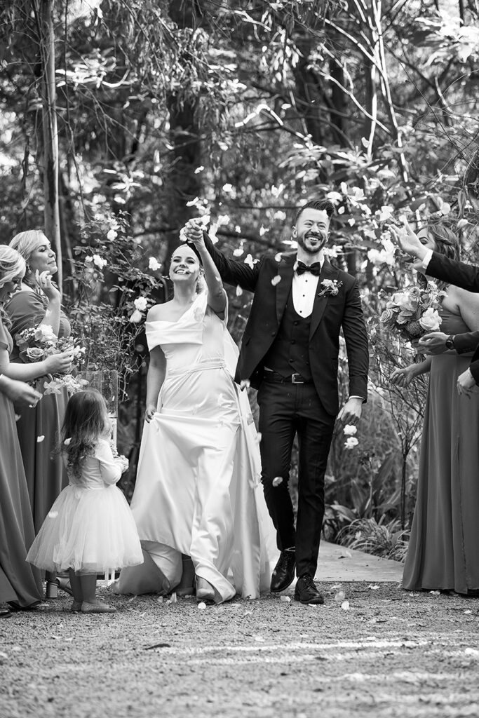 Candid moment black and white for L&N wedding by Kevin Mark Pass Photography at Lace on Timber, bridal makeup by Storm Pass