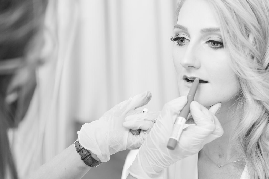 Bride getting ready with Storm Pass Makeup on her big day at Shepstone Gardens, candid wedding photography by Kevin Mark Pass
