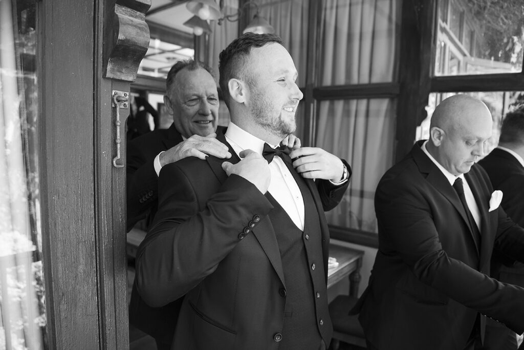 Groom getting ready for his wedding day at Shepstone Gardens, candid black & white wedding photography by Kevin Mark Pass